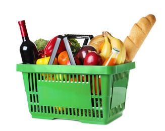 Photo of Shopping basket with grocery products on white background