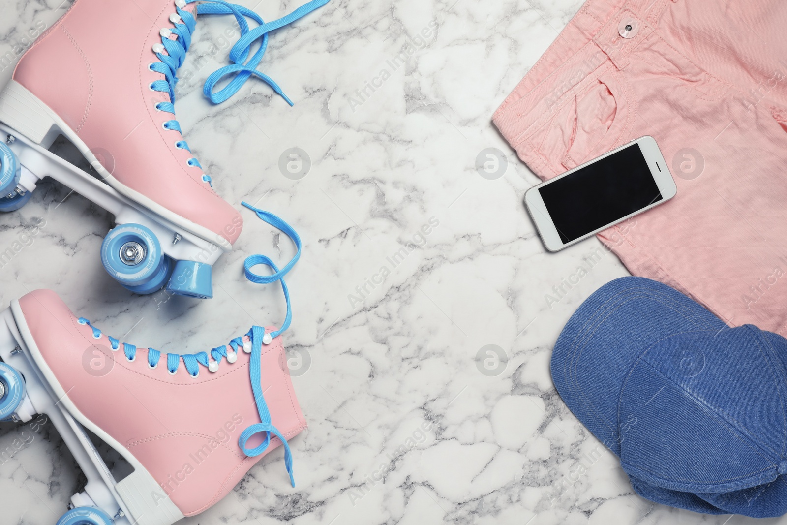 Photo of Flat lay composition with quad roller skates and space for text on marble background