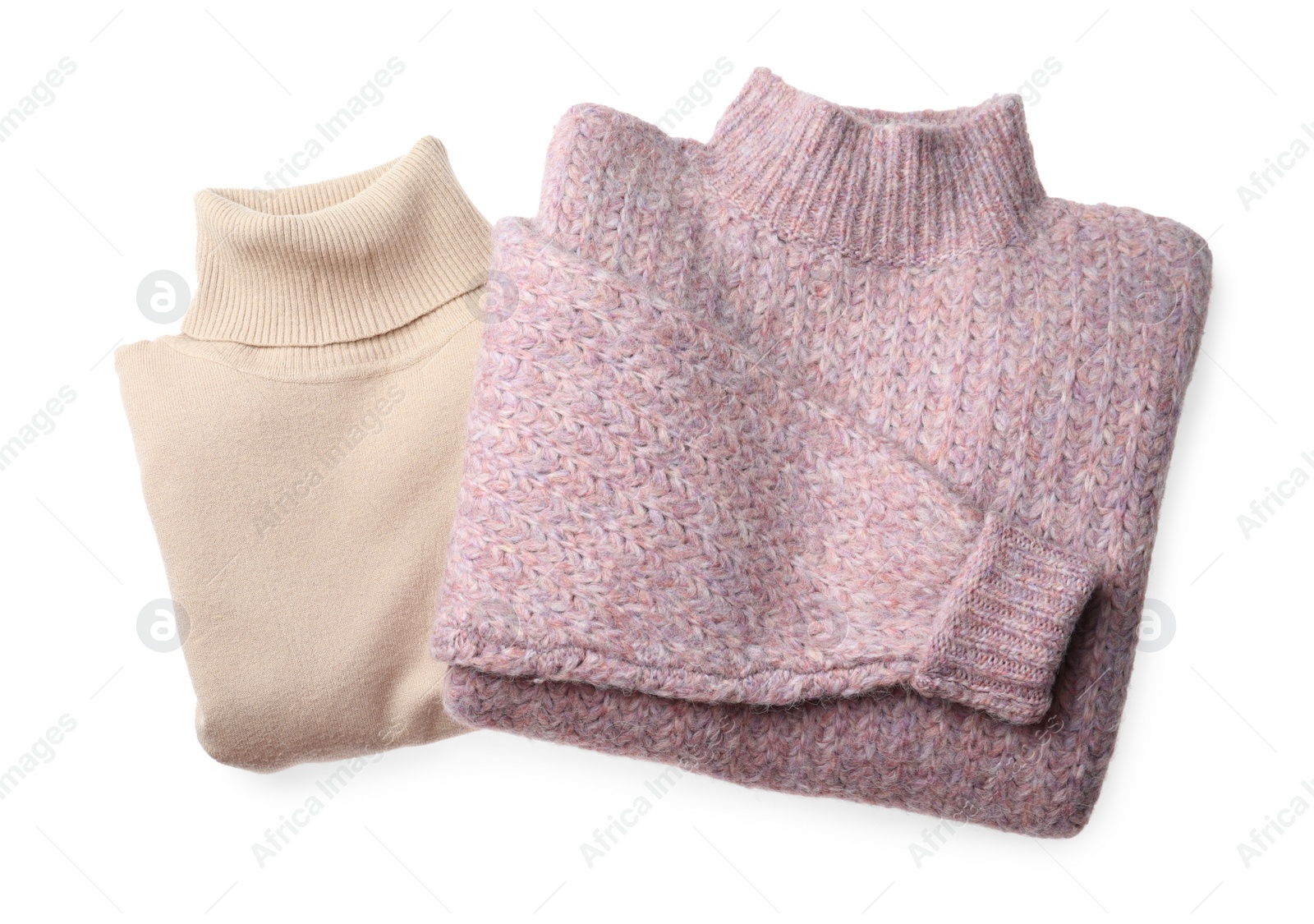 Photo of Folded warm sweaters isolated on white, top view