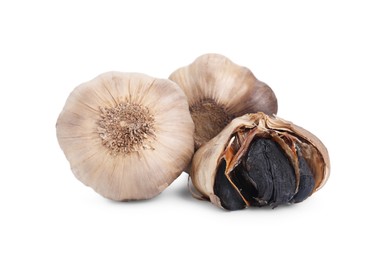 Photo of Bulbs of fermented black garlic isolated on white