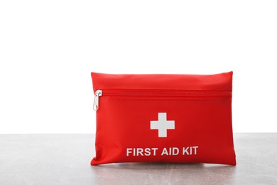 Photo of First aid kit on light grey table against white background