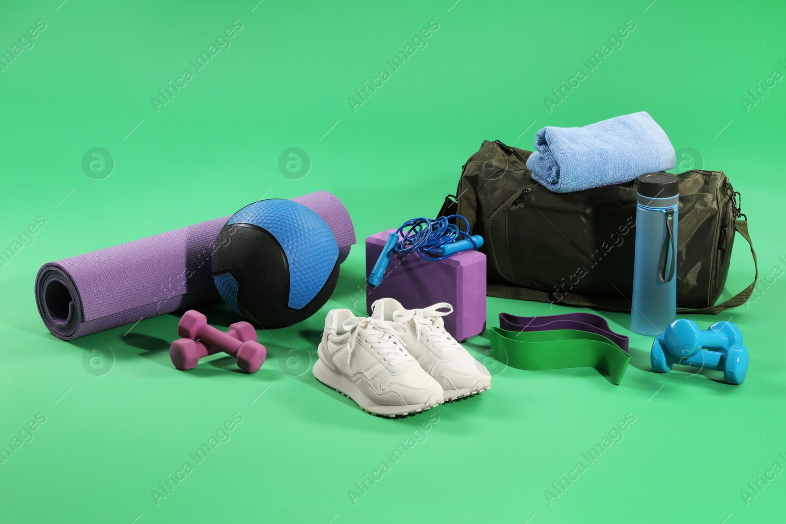 Photo of Many different sports equipment on green background