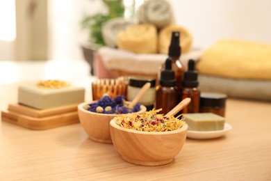 Dry flowers on wooden table indoors, space for text. Spa time