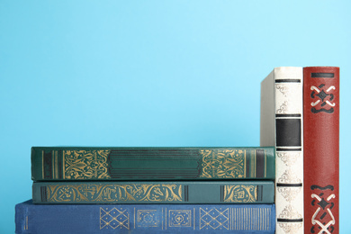 Photo of Collection of old books on light blue background