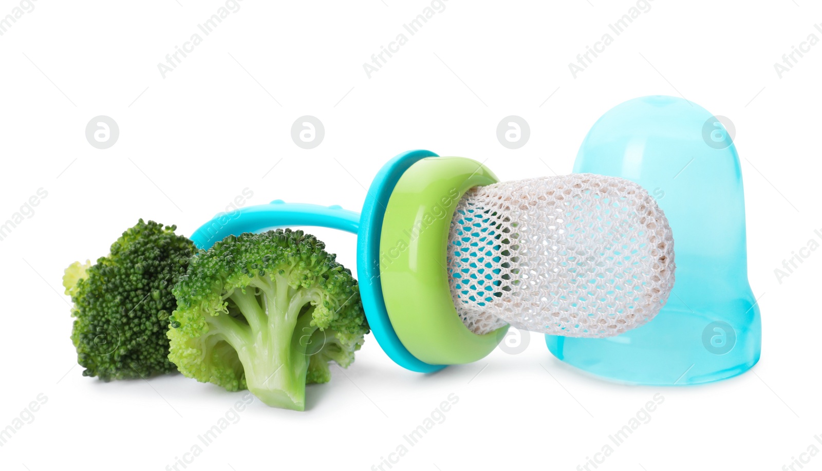 Photo of Empty nibbler and boiled broccoli on white background. Baby feeder