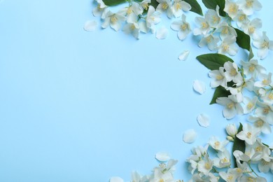 Photo of Flat lay composition with beautiful jasmine flowers on light blue background. Space for text