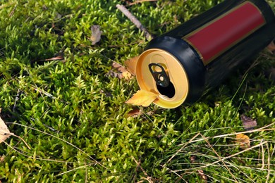 Photo of Used aluminium can on green grass outdoors, above view. Space for text. Recycling problem