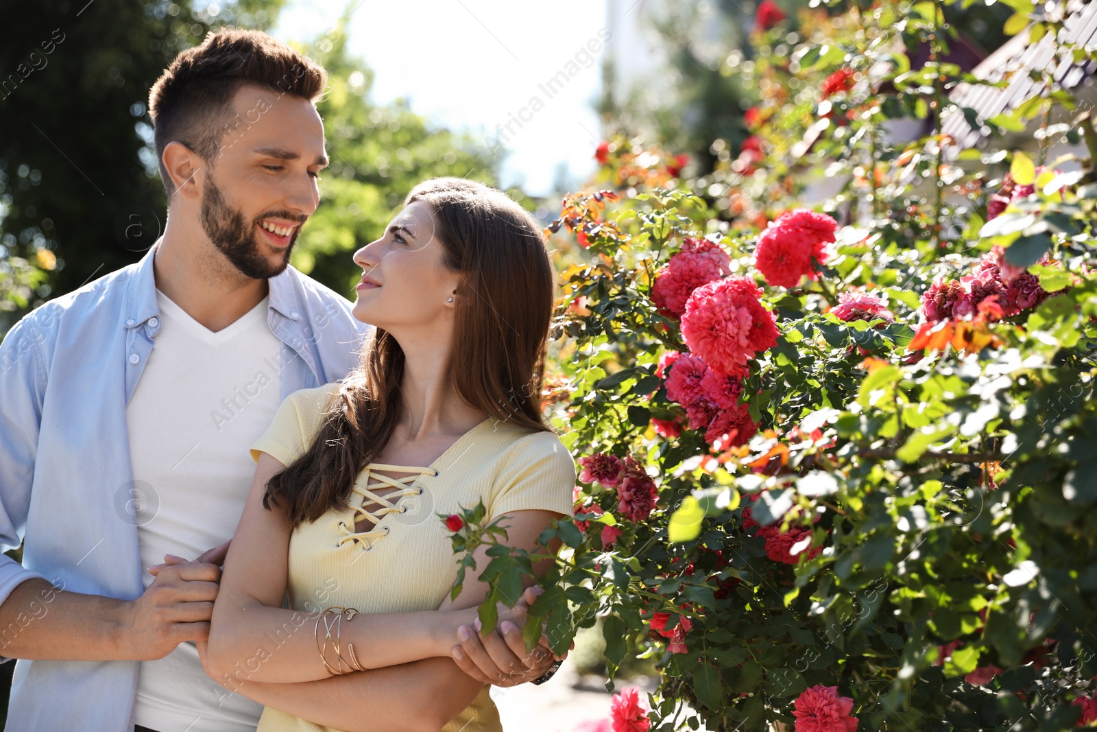 Photo of Lovely young couple dancing together outdoors on sunny day