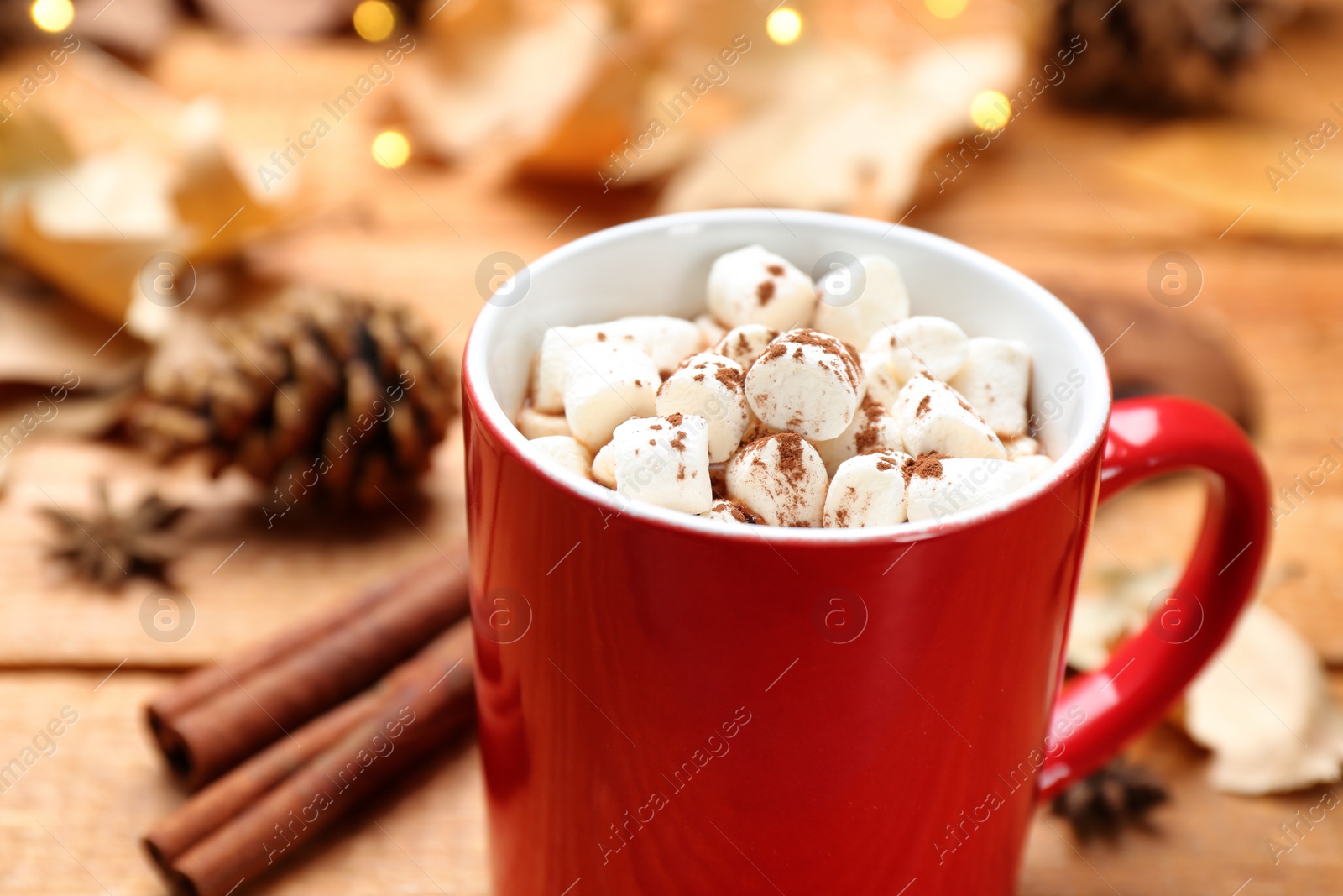 Photo of Cup of hot drink on wooden table, closeup. Cozy autumn atmosphere