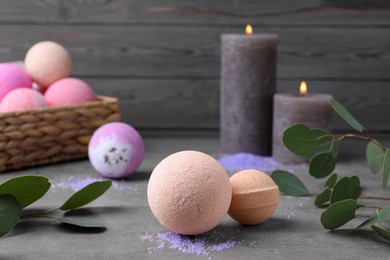 Beautiful composition with aromatic bath bombs on grey table