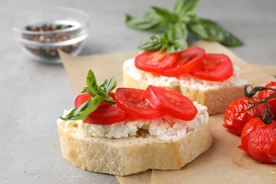 Photo of Tasty fresh tomato bruschettas on grey table