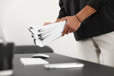 Businessman with documents in office, closeup view