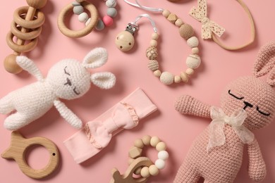 Different baby accessories on pink background, flat lay
