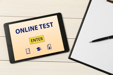 Modern tablet with online test, clipboard and pen on white wooden table, flat lay
