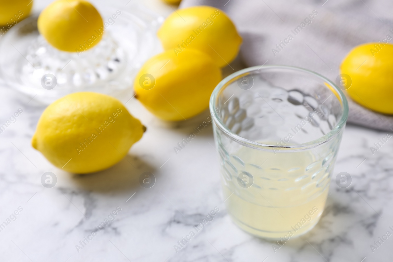 Photo of Freshly squeezed lemon juice on white marble table