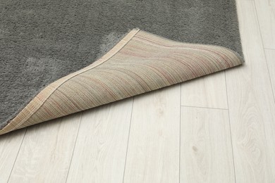 Photo of Soft grey carpet on white laminated floor indoors, space for text