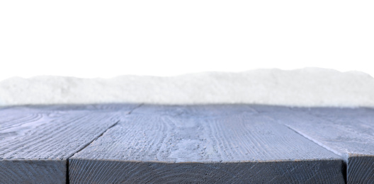 Photo of Heap of snow on grey wooden surface against white background