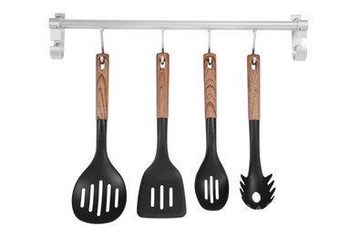 Metal rack with set of kitchen utensils on white background