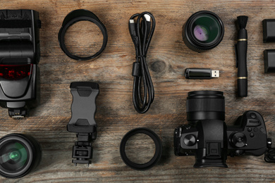 Flat lay composition with camera and video production equipment on wooden table