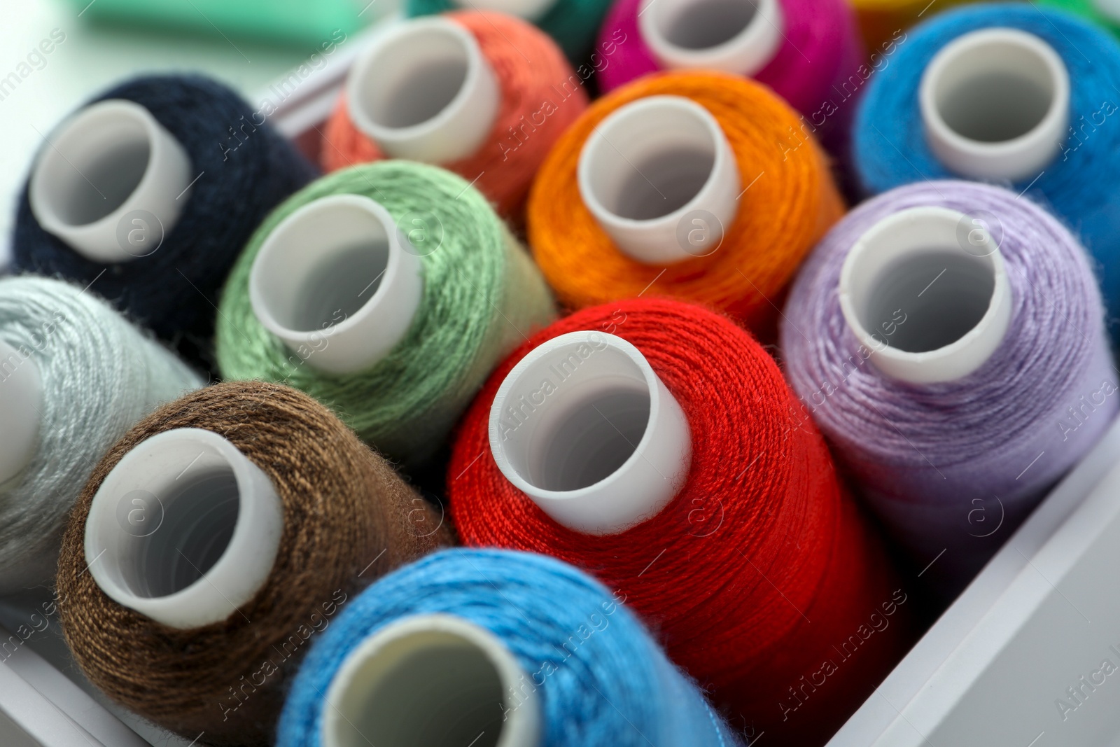 Photo of Closeup view of box with colorful sewing threads