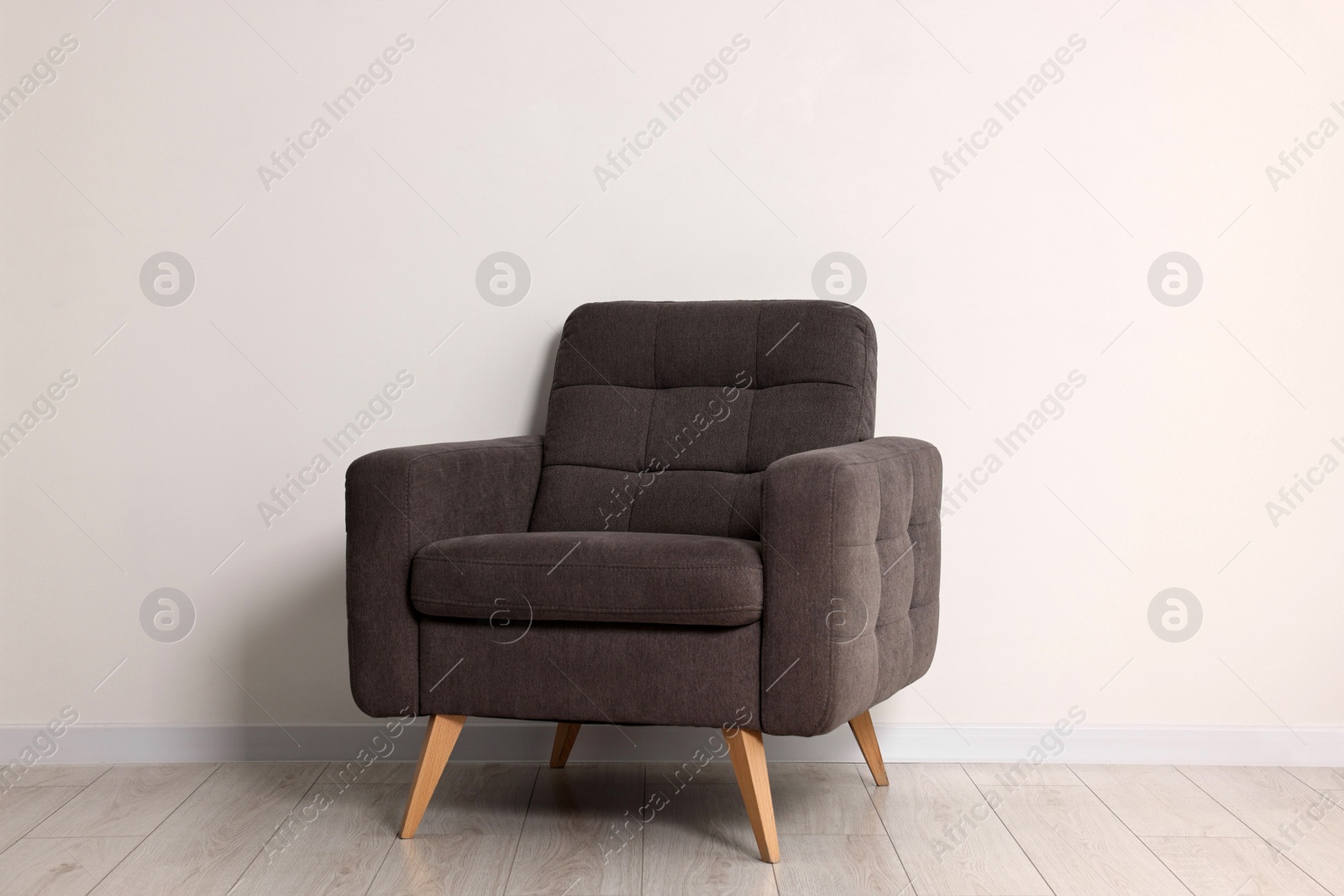 Photo of Comfortable armchair near white wall in room