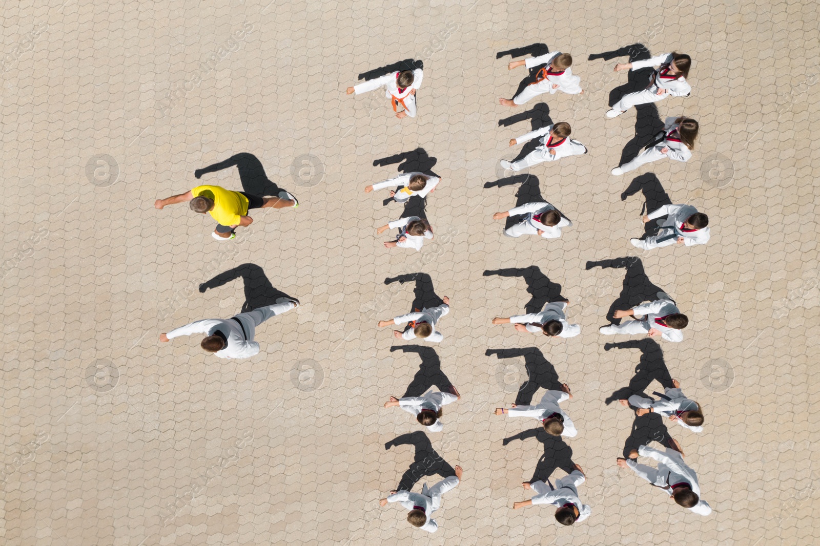 Image of OCHAKIV, UKRAINE - JULY 09, 2020: Children practicing karate with coaches outdoors, aerial top view. Spending time in summer camp "Sportium"