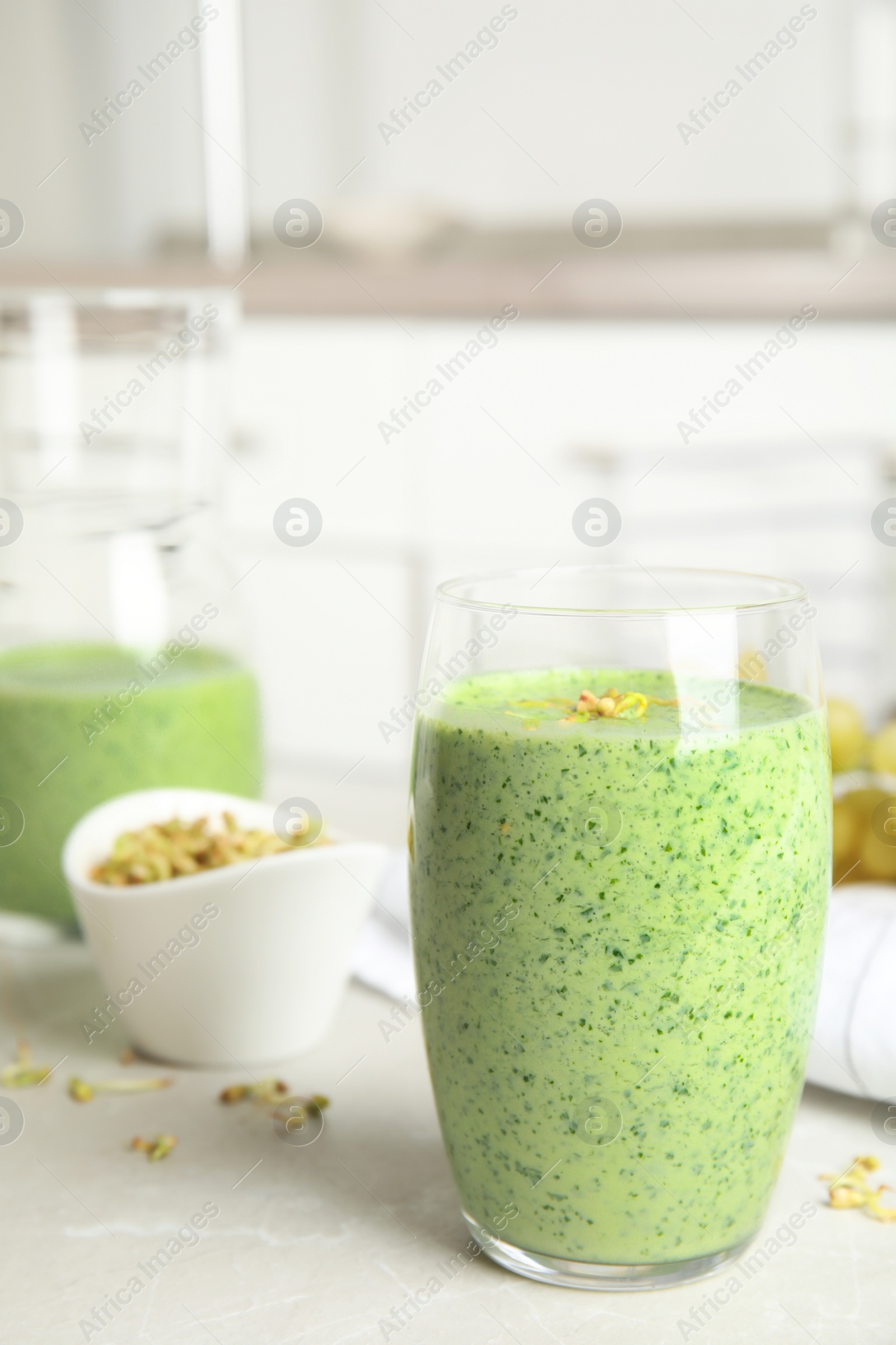 Photo of Green buckwheat smoothie on light grey marble table