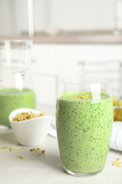 Green buckwheat smoothie on light grey marble table