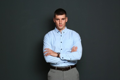 Portrait of handsome young man on dark background