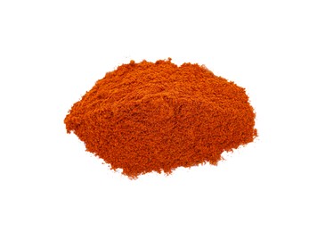 Photo of Heap of aromatic paprika powder isolated on white