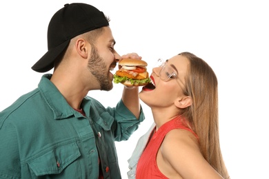 Happy couple eating burger isolated on white