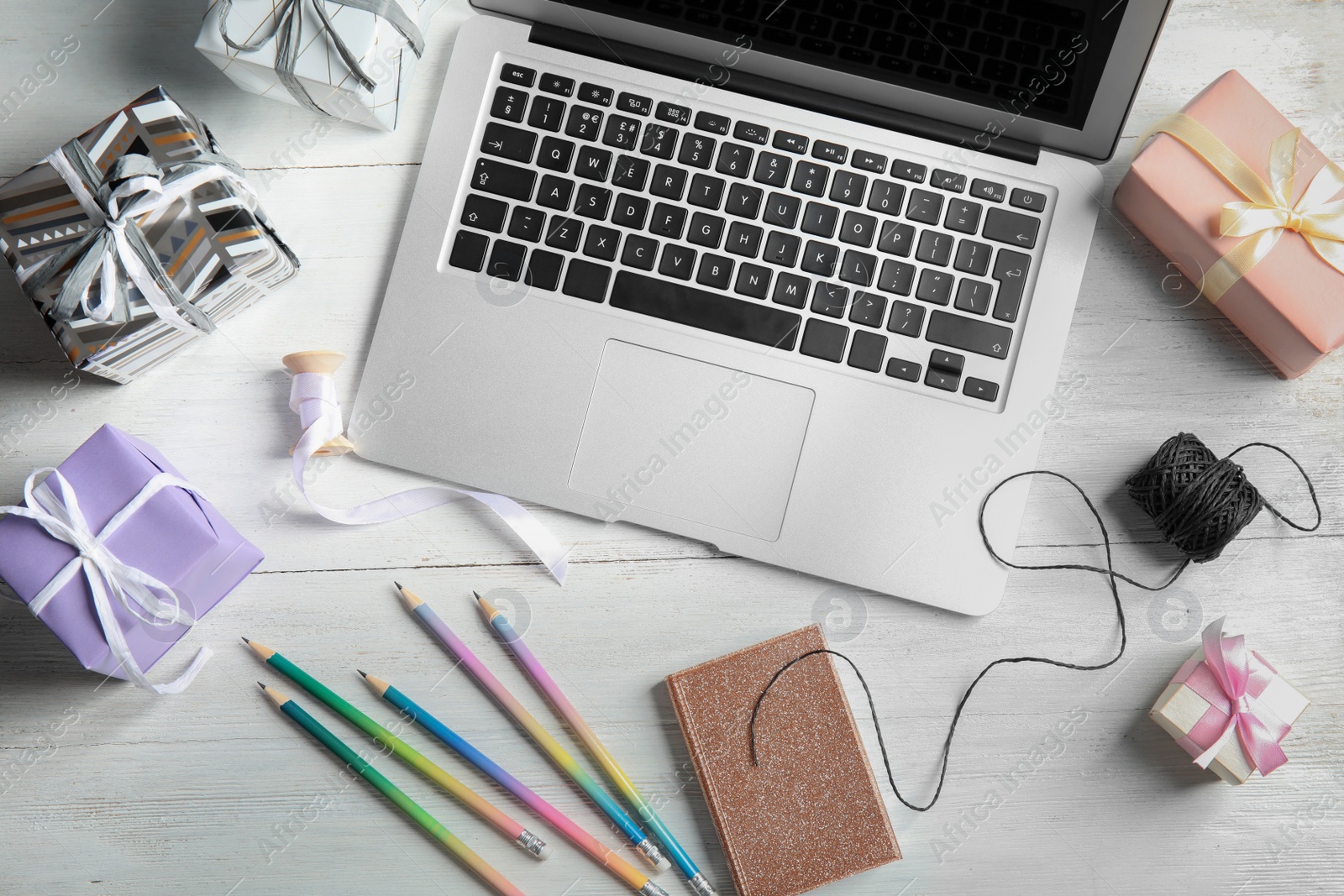 Photo of Flat lay composition with laptop on wooden table. Blogger's workplace