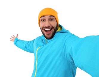 Smiling young man taking selfie on white background