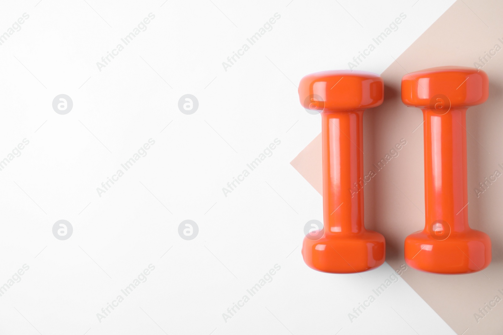Photo of Vinyl dumbbells and space for text on color background, flat lay