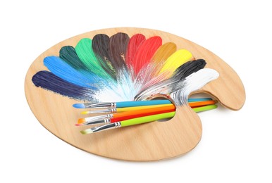 Photo of Palette with paints and brushes on white background. Artist equipment