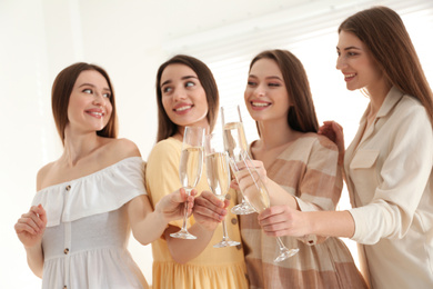 Photo of Beautiful young ladies toasting indoors. Woman's Day