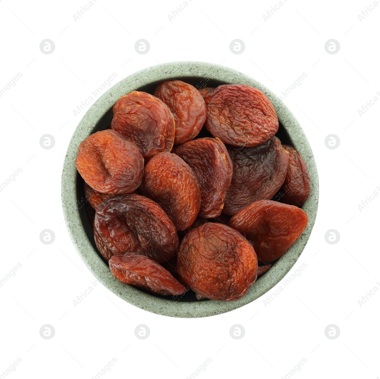 Photo of Ceramic bowl with tasty dried apricots isolated on white, top view