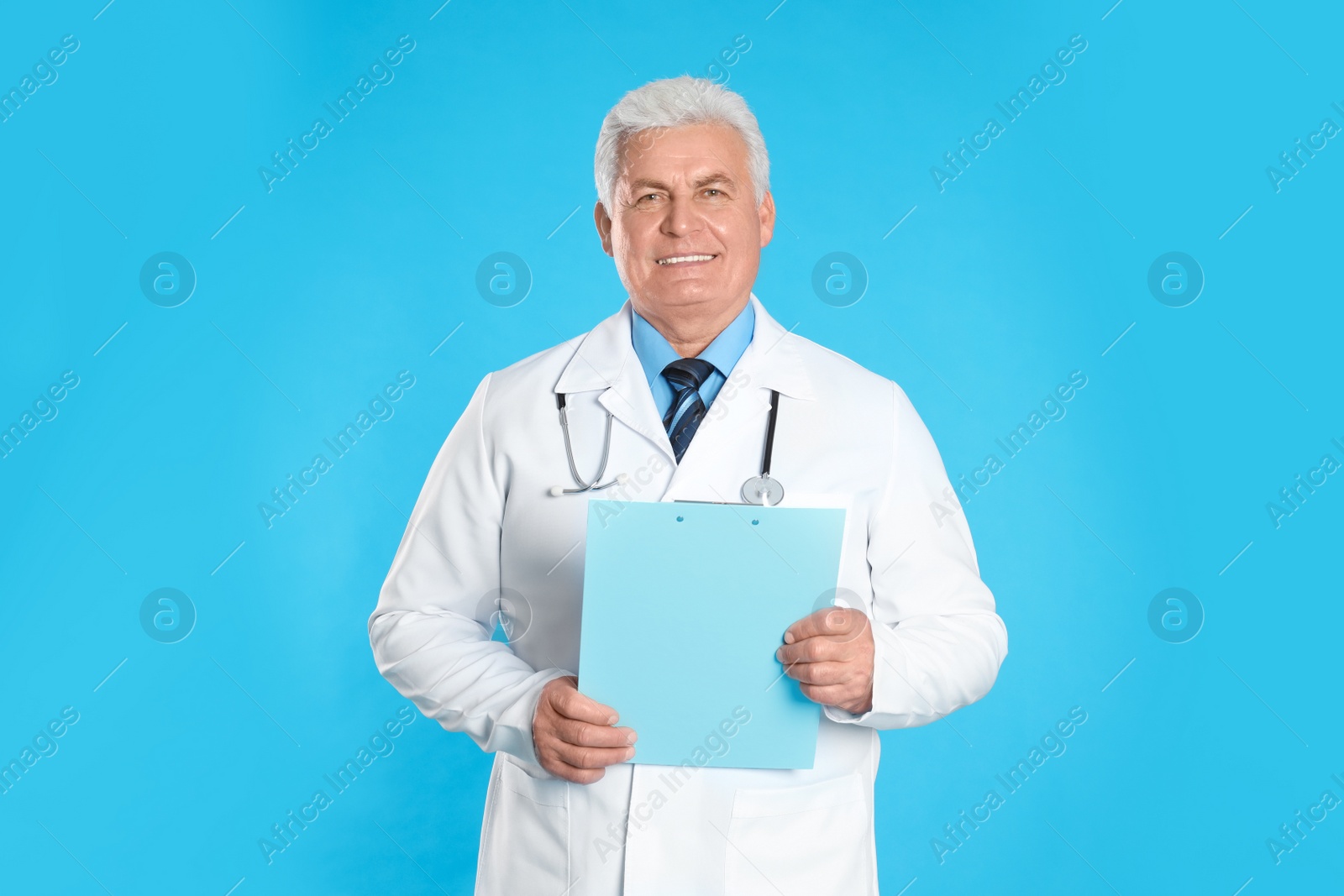 Photo of Senior doctor with clipboard on light blue background