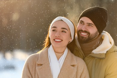 Beautiful young couple enjoying winter day outdoors