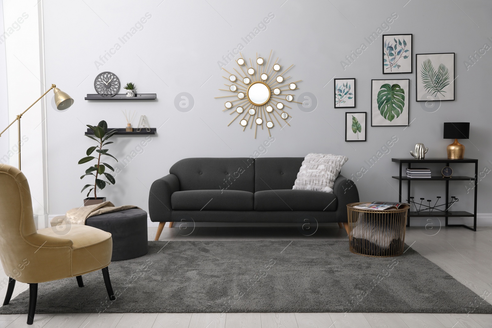 Photo of Stylish living room interior with comfortable sofa and floral pictures