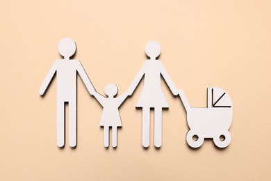 Photo of Figures of family on beige background, top view. Insurance concept