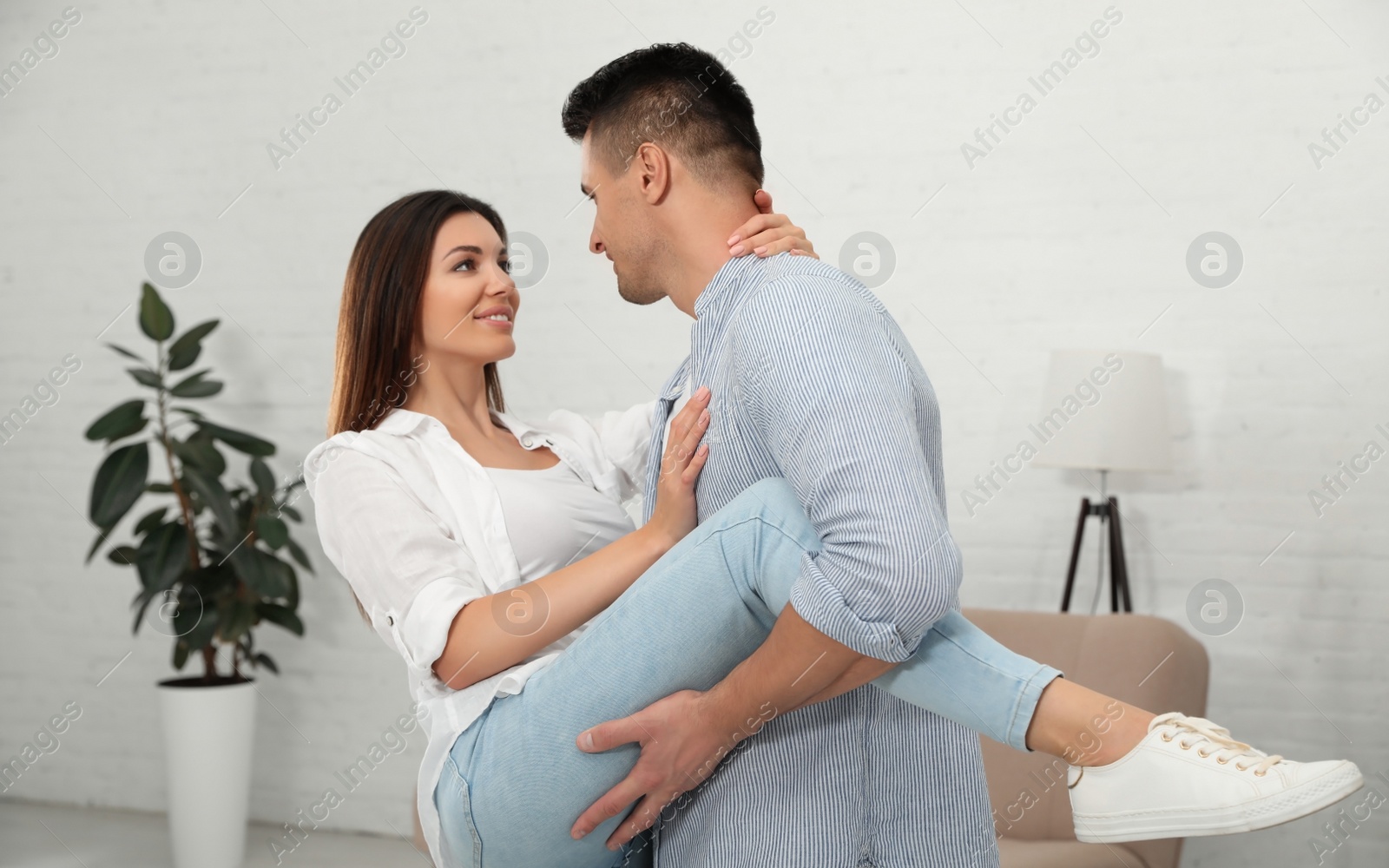 Photo of Happy couple dancing in living room at home