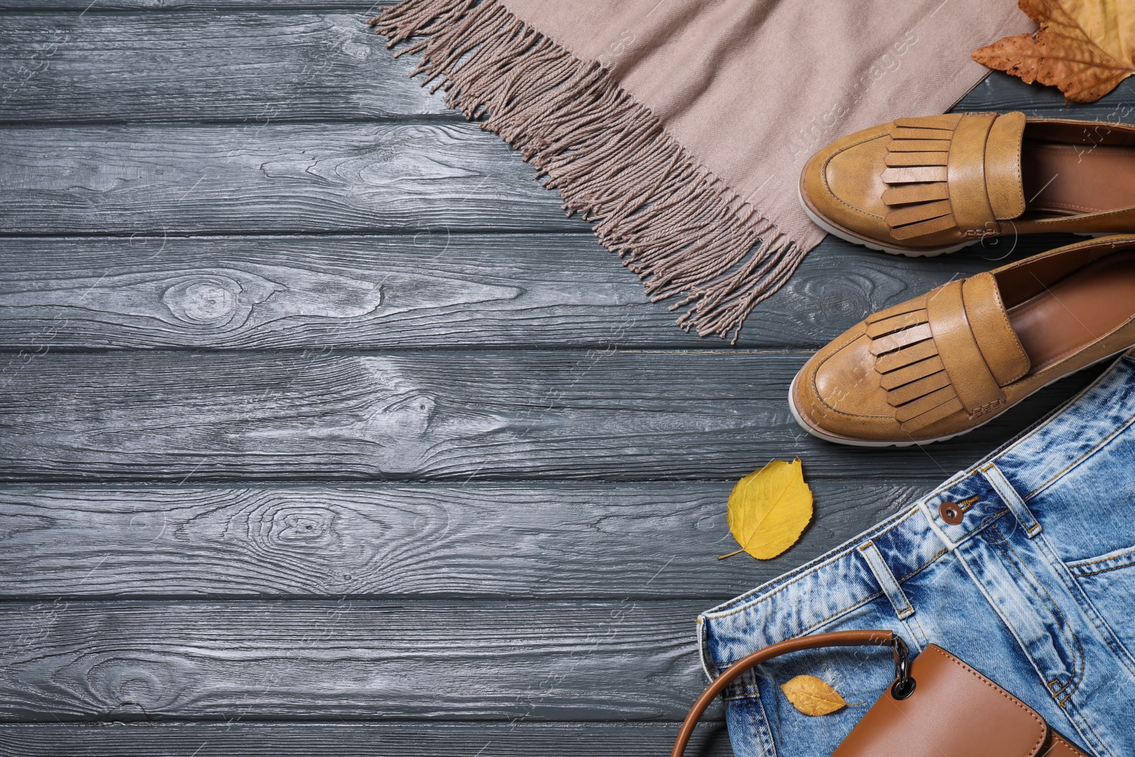 Photo of Flat lay composition with autumn clothes and accessories on grey wooden table. Space for text