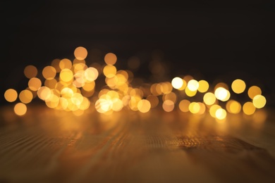 Empty wooden surface and blurred lights on background. Bokeh effect