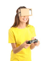 Young woman using cardboard virtual reality headset, isolated on white