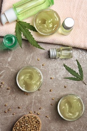 Flat lay composition with hemp lotion on grey background