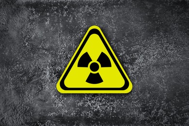 Image of Radioactive sign on grey wall. Hazard symbol
