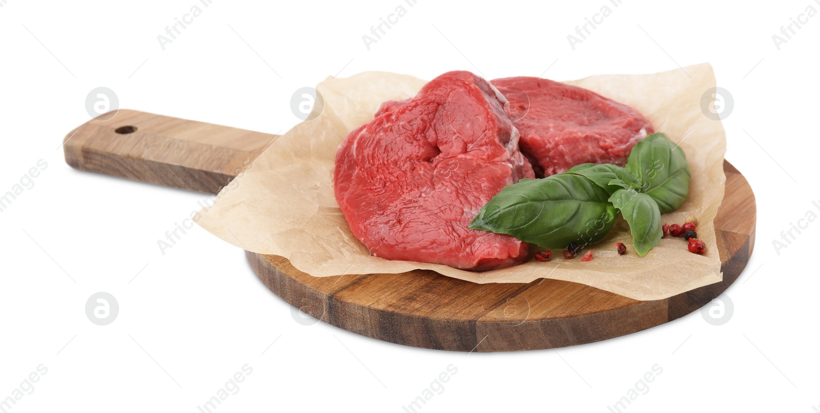 Photo of Fresh raw cut beef with basil leaves isolated on white