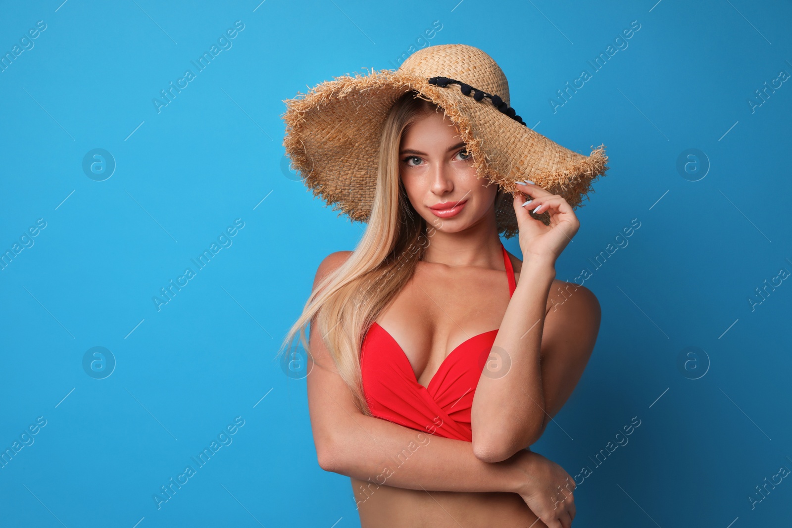 Photo of Pretty young woman wearing stylish bikini on blue background