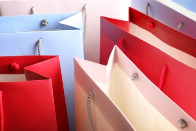 Colorful paper shopping bags as background, closeup